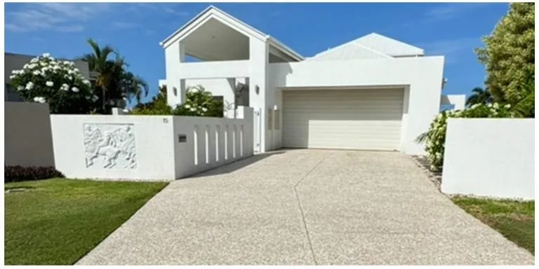 Modern white house with a freshly cleaned driveway, ready for a rental turnover